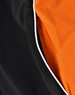 A close-up of a unisex jacket featuring a black exterior with an orange interior and contrasting white piping.