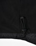 A close-up of a black unisex jacket featuring a pull cord at the hem, with a soft textured finish.