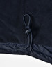 A close-up of a navy unisex jacket featuring a drawstring at the hem and a smooth fabric texture.