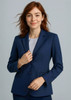A woman in a navy longline jacket with a fitted design, featuring a single button closure and minimalistic style.