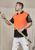 A man wearing an orange and black short sleeve polo shirt stands holding a green pole. The shirt has a logo.