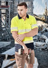 A short sleeve polo shirt in hi-vis yellow with navy segments and reflective tape, worn by a man holding tools.