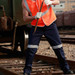 Unisex adults cotton drill work pants in navy with reflective tape, worn by a person in an orange hi-vis vest.