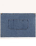 A denim half apron in blue with a front pocket and brass button accents. It has a simple, functional design.