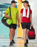 A sports travel bag in black with green and red accents, alongside two individuals in activewear and caps.