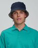 A contrasting underbrim bucket hat in navy, featuring a light-coloured underbrim, worn with a teal polo shirt.