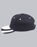 A black structured cap with a contrasting white peak and decorative stripes on the brim, featuring a logo.
