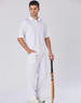 A model wearing white men's cricket pants, paired with a matching polo shirt, holding a cricket bat.