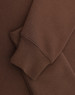 A brown 1/2 zip collar fleecy sweat featuring a smooth fabric and a cuffed sleeve. Includes branding.