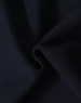 A close-up of dark navy fabric, showcasing the soft texture of a fleecy hoodie material.