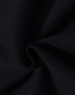 A close-up of black fabric with a soft texture, demonstrating a fleecy material suitable for hoodies.