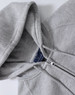 A grey full-zip fleecy hoodie featuring a hood and stitched detailing, with branding visible inside.