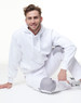 A white fleecy hoodie with a front pocket, featuring a logo, worn with matching light grey pants.
