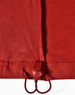 A red softshell vest featuring a drawstring adjuster at the hem and a smooth textured fabric.