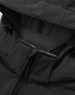 A close-up of the black softshell hoodie with a zippered pocket and a hood. It features a logo on the fabric.