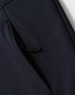 A navy softshell full zip hoodie featuring a zippered pocket on the side and a logo.