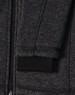 A dark heather grey fleece jacket with a black ribbed cuff and zipper detail. It also features a logo.
