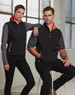 Men's softshell contrast vest in black with grey sleeves and orange accents, featuring a zipper and pockets.
