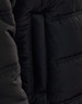 A close-up of a black heavy quilted jacket, highlighting the texture and stitching. The jacket features a brand logo.