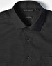 A black pin dot stretch long sleeve shirt featuring a button-up collar and a chest pocket, with branding on the label.