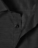A black long-sleeve button-up shirt featuring a pin dot pattern and a collar, with a logo present.