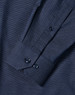 A men's long sleeve button-up shirt in navy with a pin dot pattern and cuff details. Features a logo.