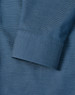 A detailed close-up of a blue men's button-up shirt featuring a pin dot pattern and a cuff.