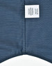 A button-up shirt featuring a pin dot pattern in navy blue, with a care label attached.