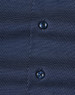 Men's long-sleeve button-up shirt in navy with a pin dot pattern and two dark buttons. Features subtle texture.