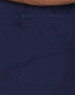 A navy scrub top featuring a large pocket and contrast brown collar. Includes a logo.