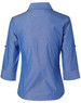 A blue women's button-up shirt with 3/4 sleeves, featuring a collar and rolled-up cuffs. The shirt has a logo.