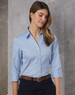 A light blue women's button-up shirt with 3/4 sleeves, featuring a collar and a sleek design, paired with a belt.