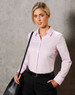 A light pink long-sleeve button-up shirt, featuring a collar and paired with black trousers and a handbag.