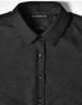 A black pin dot stretch long sleeve button-up shirt with a collar and branded tag.