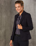 A cropped women's blazer in navy with a single button, paired with a dark shirt and sleek hairstyle.