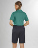 A woman in a green polo shirt and black utility cargo shorts, viewed from the back. The shorts have pockets and are knee-length.