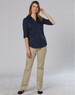 A woman wearing navy and khaki women's chino pants, styled for a casual look with a collared shirt.
