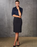 A mid-length lined pencil skirt in black, paired with a navy shirt and black high heels. It has a logo.
