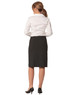A black wool stretch pleated skirt, seen from the back, paired with a white shirt and heeled shoes.