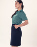 A ladies' utility cargo skirt in navy, featuring pockets and styled with a green polo shirt.
