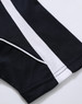 A close-up of a black polo shirt with white stripes, featuring a logo on the fabric.