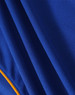 A close-up view of a blue polo shirt with an orange trim, featuring a textured fabric and a logo.