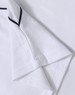 A white kids’ polo shirt with short sleeves and black detailing, featuring a logo.