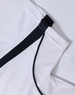 A white polo shirt with black trim and a textured fabric. It has a logo featured on it.