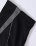 A black polo shirt featuring a grey trim along the shoulder seams and has a branding logo.
