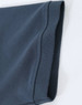 A close-up of a navy blue men's cotton stretch polo shirt, highlighting the fabric and sleeve detail.