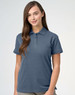 A ladies cotton stretch polo in a soft blue colour, featuring a collar and short sleeves. The garment has a logo.
