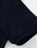 A navy blue ladies cotton stretch polo with a close-up view of the sleeve. It features a logo.