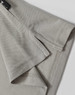 A light grey polo shirt featuring detailed stitching and a branded label at the collar.
