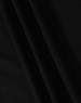 A close-up of black fabric, featuring smooth folds and a soft texture, ideal for a polo shirt.